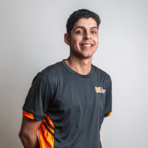 Daniel, site supervisor at ONQ Building Group, smiling in a grey and orange team shirt, emphasizing commitment to quality home renovations.