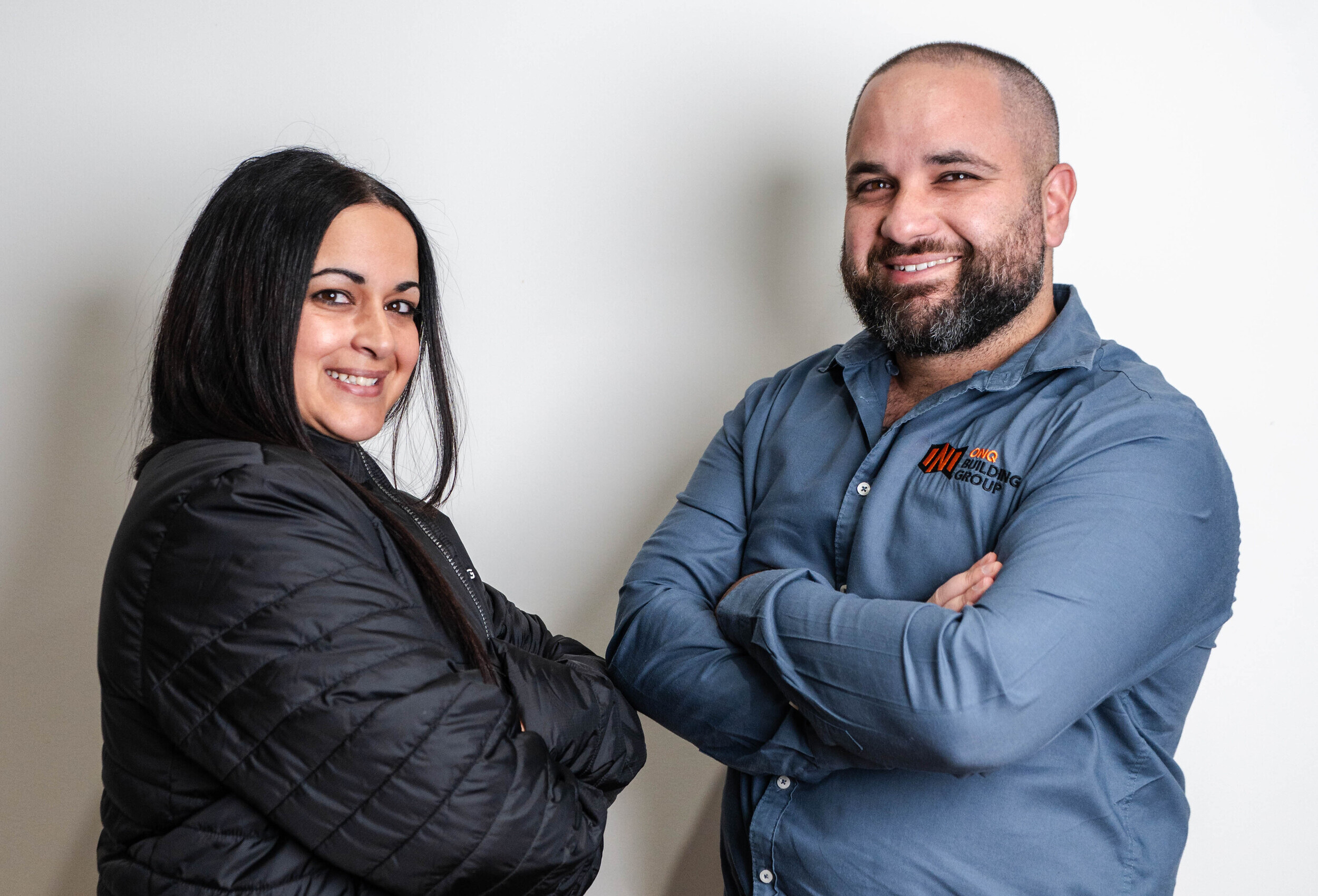 Brendan and team member smiling, showcasing ONQ Building Group's commitment to quality and client relationships in home renovations.